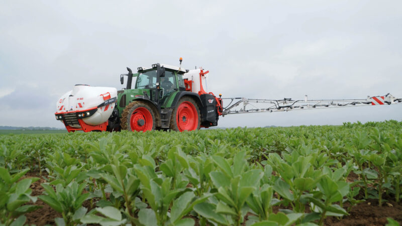 Photo du pulvérisateur frontal PF 1500 en combinaison avec ALTIS 2 au travail vu de côté